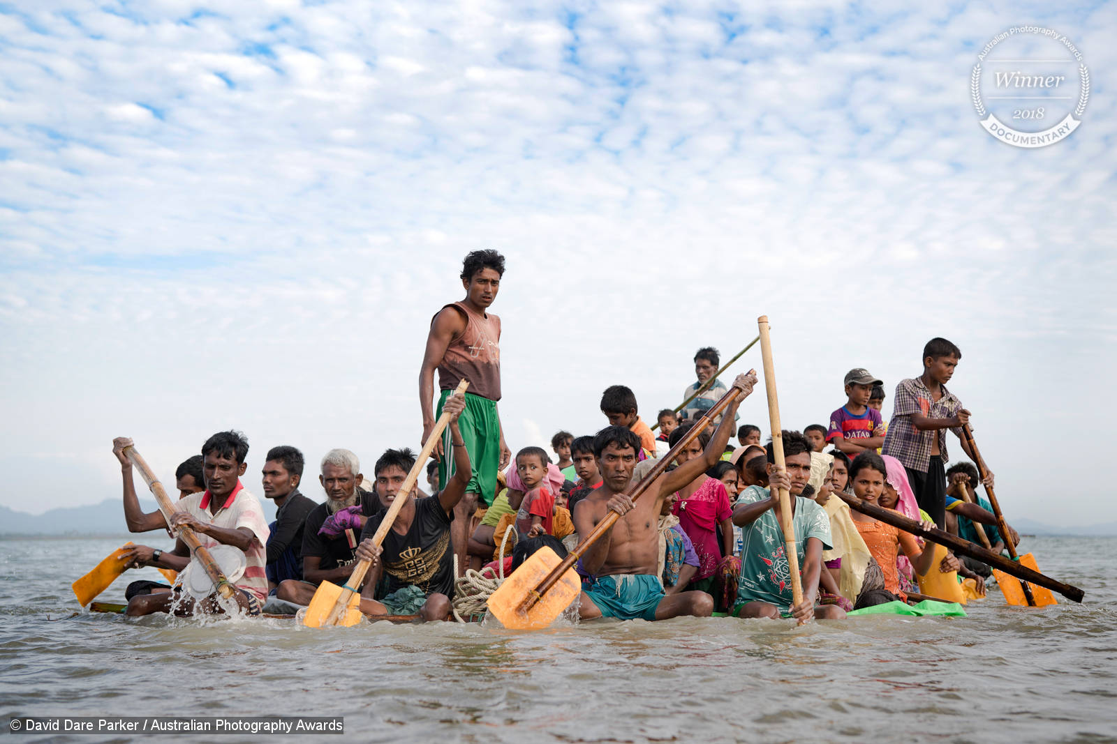 Sunday 12th November 2017. After 16 - 20 days waiting on the Myanmar border, Rohingya refugees cross the Naf River into Bangladesh using eight makeshift rafts made out of bamboo and plastic palm oil containers. Often described as the "world's most persecuted minority", the Rohingya are a Muslim ethnic group from the Rakhine State in Myanmar. In October 2016, a military crackdown in the wake of a deadly attack on an army post sent hundreds of thousands of Rohingya fleeing to neighboring Bangladesh. This most recent exodus from Rakhine state, Myanmar, to the makeshift camps that have sprung up in Coxs Bazar District, began August 25, 2017, when militants from the Arakan Rohingya Salvation Army targeted about 30 police posts and an army base, killing several people. So far more than 650,000 people have fled into Bangladesh, swelling the camps and creating a humanitarian crisis. Photograph by David Dare Parker